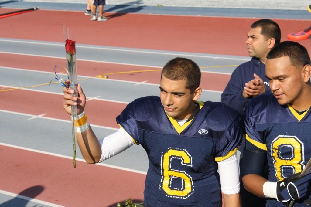 #6 Izaiah G. holding his rose for his last game as a senior.