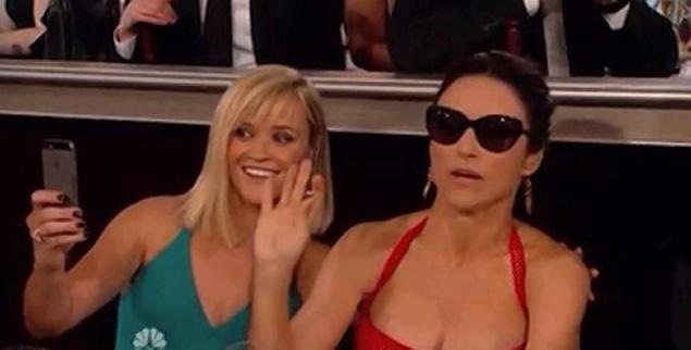 A too cool, Julia Louis-Dreyfus, smoked an e-cig and then denied Reese Witherspoon of a picture. 