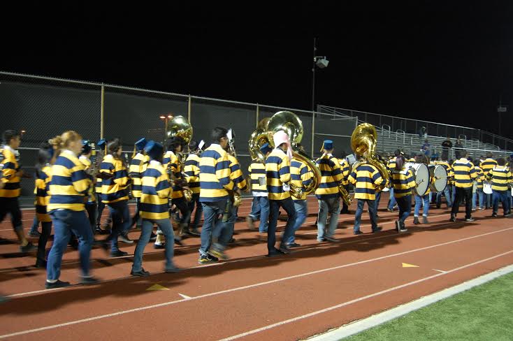 The Pep Band walks off the field after their half-time performance on Sept. 12.