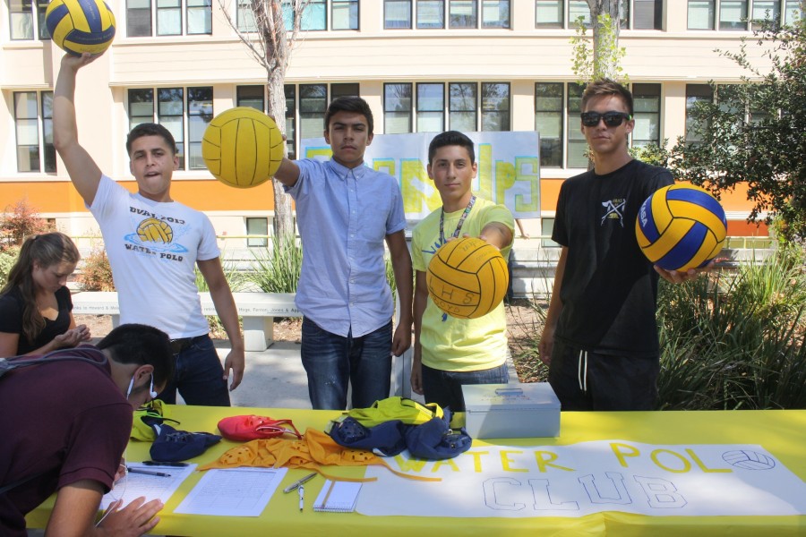 Members of the water polo team, Juan Lopez, Nelson Pena, Efrain Navarro, and Tyler Giles pose with their water polo balls.