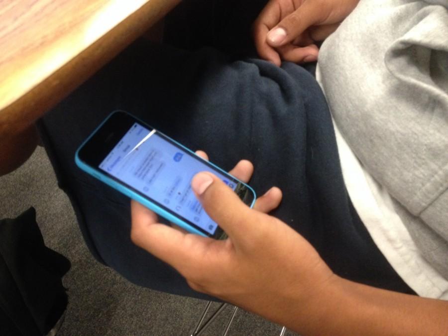 Student+tries+to+hide+his+phone+under+his+desk.