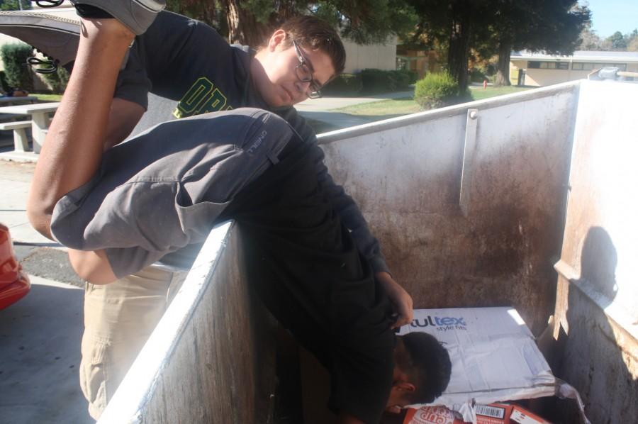 Jonathan throws Javier into a dumpster.