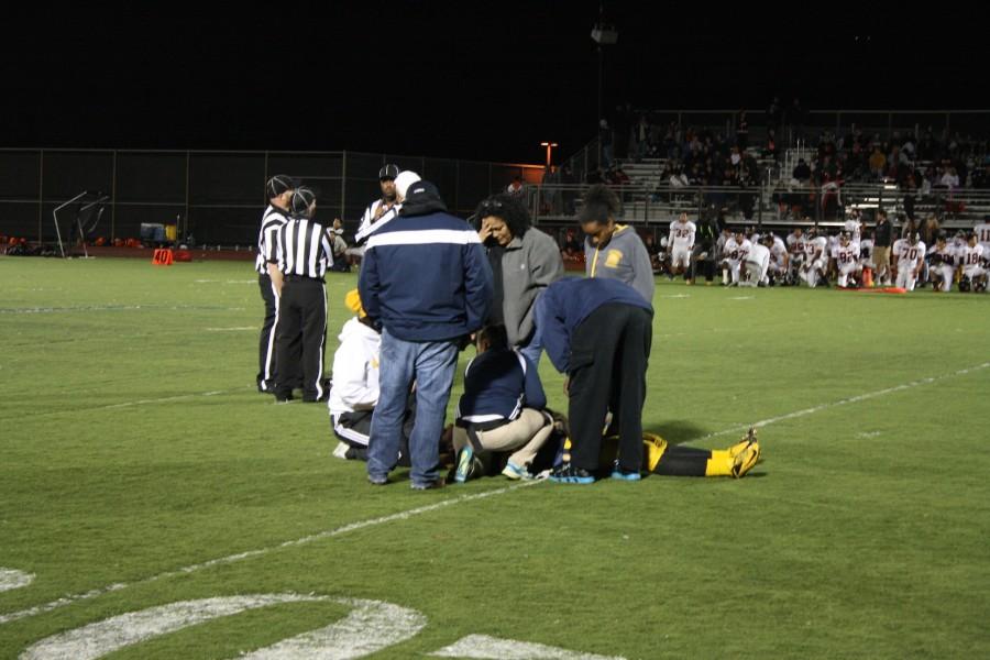Coaches+and+family+members+attend+to+Varsity+player+Adrian+Frometa+%28lying+down%29+following+his+injury+during+the+4th+quarter+of+the+game+versus+Silver+Creek+on+Nov.+14.