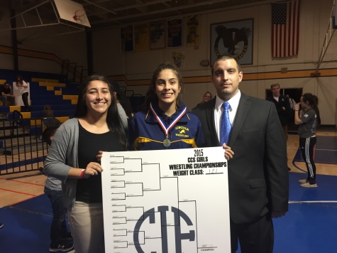 Haven poses with her older sister, c. .(left) and Coach Lopez(right).