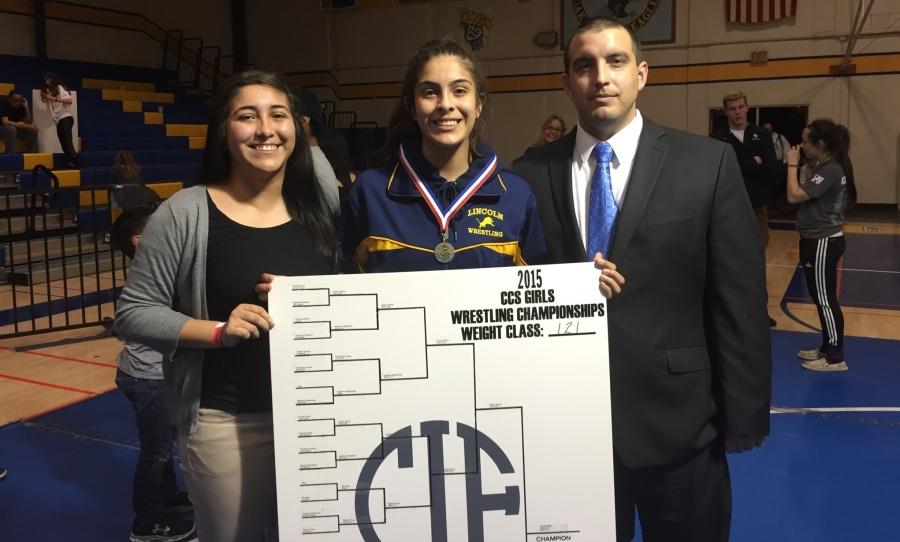 Haven poses with her older sister, c. .(left) and Coach Lopez(right).