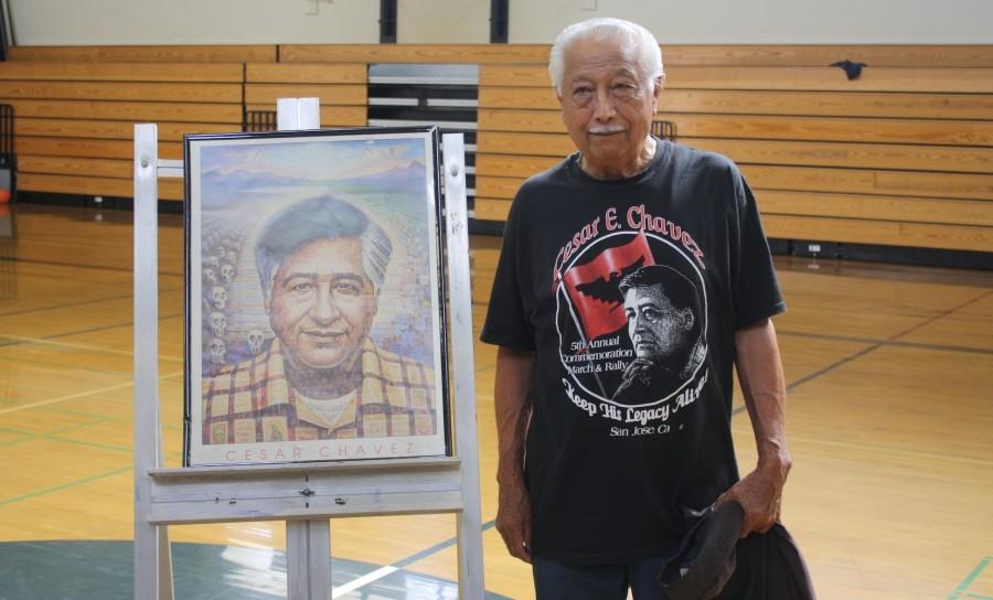 Librado Chavez poses next to a portrait of his older brother, Cesar Chavez.