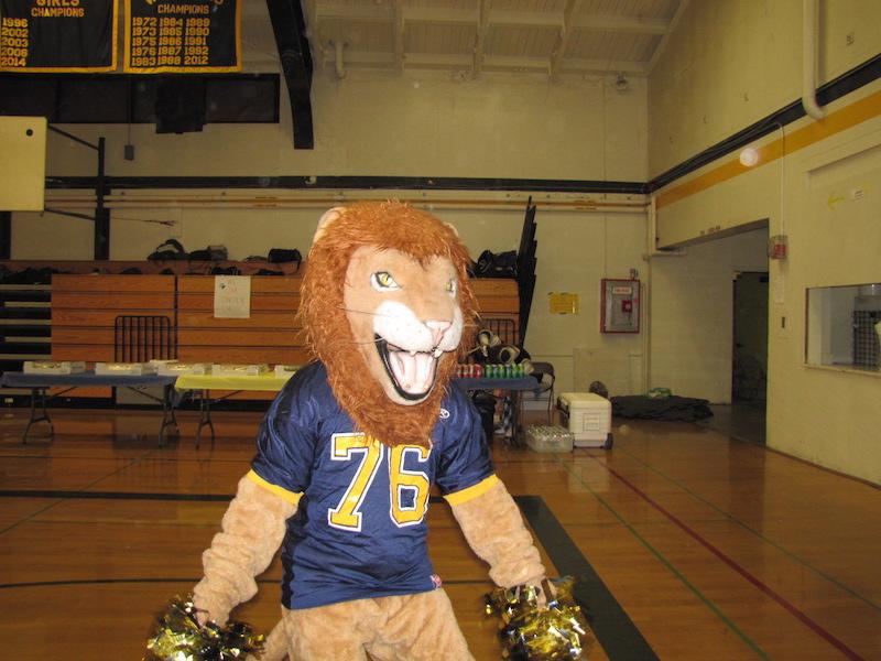 Ryan Ruffing poses in the Lincoln Lion mascot costume (Jacqueline Moncada/Lion Tales)