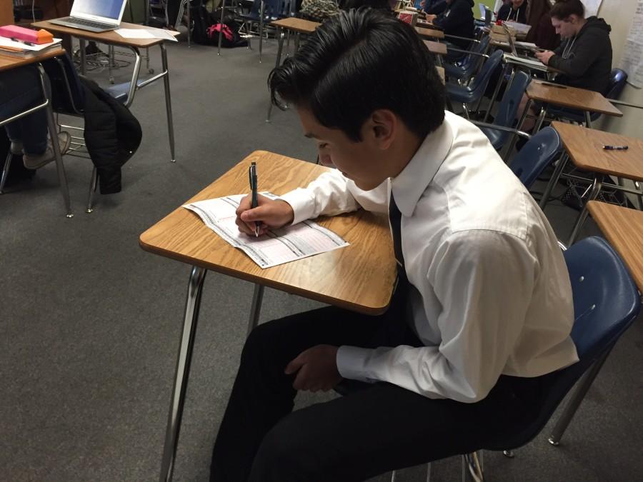 Santiago Robles fills out the application for free and reduced price meals.