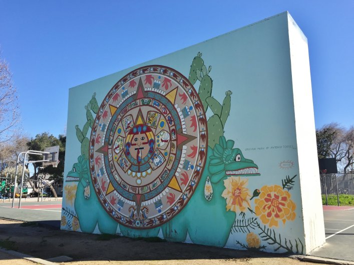 This Aztec calendar mural in San Jose's Biebrach Park, originally painted
by Antonio Nava Torres in 1995, is one of the murals that will be showcased
in a community bike ride sponsored by the Silicon Valley Bicycle Coalition
on Saturday, March 4, 2017. (Sal Pizarro/Staff)