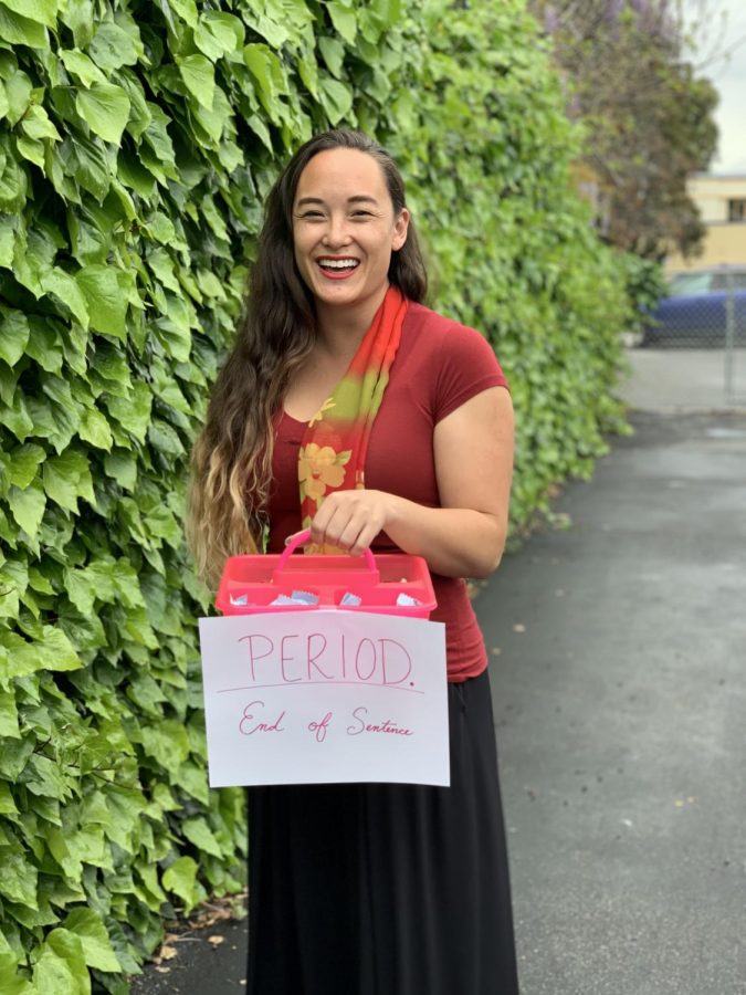 Ms. Kolling, leader of Lean In Feminist Club, holding upping box, part of Pink Box Initiative. 