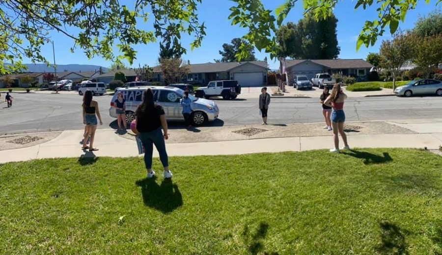 Teammates surprising friend on her birthday by driving by and spray painting a car, all while respecting social distancing protocols (Ariana Noble/Lion Tales)
