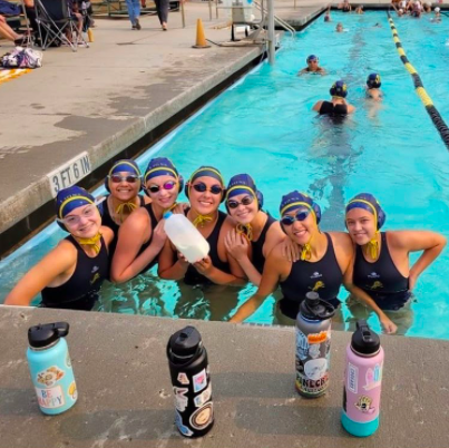 Members of the Girls Water Polo team smiling for the camera.